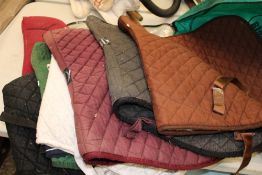 A quantity of used horse riding saddle pads: including Weather Beeta etc (approx 8).