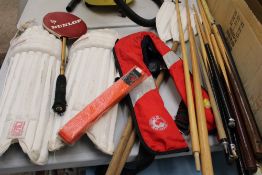A mixed sporting equipment lot: cricket pads, orange karate belt, pair of oars and a collection of