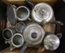 A collection of pewter tea service items: teapot, water jug, milk jugs, sugar bowls etc (1 tray).