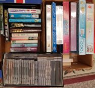A mixed collection of books, jigsaw puzzles and CD's: