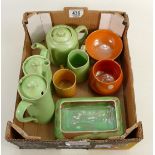 A collection of early Moorcoft Burslem pottery items:including green /orange glazed teapots,