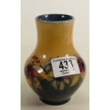 Walter Moorcroft small vase decorated with Orchids: with unusual Ochre/blue ground, h.12.75cm. (