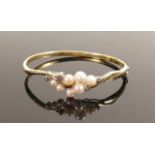 9ct gold bangle set cultured pearls and white stones: Gross weight 9.1g