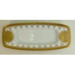 A porcelain long sandwich tray: Gilded all around with various playing fairies, length 46cm x