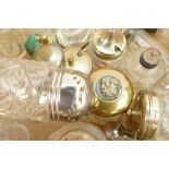 A collection of vintage glass storage bottles and jars: Some with silver lids, scent bottles etc. (