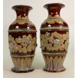 A Pair of Doulton Lambeth vases decorated with scrolling foliage: by George Tinworth height 28.