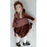 Large pottery headed doll: Marked 12 to rear of head, height 70cm.