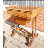 Victorian Walnut games and sewing table: Top has slight warp.