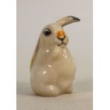 Royal Doulton early seated lop eared rabbit: Decorated in natural colours, height 10.5cm.