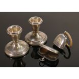 A collection of silver items: Including silver baby's rattle, pair of filled small candlesticks,