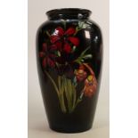Walter Moorcroft vase in the Spring Flowers design: On dark blue/red ground, height 26.5cm.