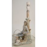 Lladro figural lamp base boy & dog seated by tree: Height 31cm.