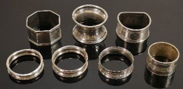 6 silver serviette rings: 91g and a silver plated example. (7)