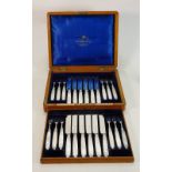 Mother of pearl handled silver hallmarked fruit knives and forks: Cased set for 12 persons in 2
