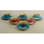 A collection of early Aynsley Orchard Gold tea cups: In various colourways. (12)