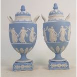 A Wedgwood pair of 19th century light blue dip Jasperware urn & covers: Decorated with dancing hours