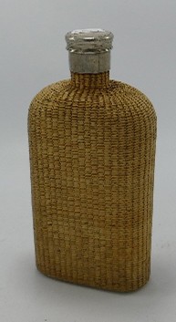 Large Wicker clad spirit bottle: With pewter screw top lid, height 22cm.