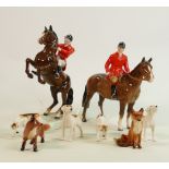 Set of Beswick hunting figures: Two mounted huntsman, four foxhounds and two foxes. (8)