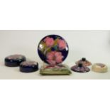Collection of seven Moorcroft pot lids: Orchid, Clematis, Hibiscus etc.