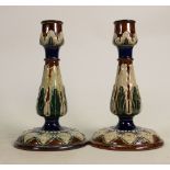 A Pair of Doulton Lambeth candlesticks: Decorated with flower heads by Emily Partington, height