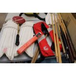 A mixed sporting equipment lot: cricket pads, orange karate belt, pair of oars and a collection of