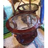 A matching pair of mahogany and glass circular coffee tables: (2).