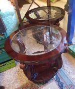 A matching pair of mahogany and glass circular coffee tables: (2).