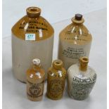 Five ceramic bottles to include: G & J Munro & co Hanley, Howarth Brothers's Birmingham, Steward &