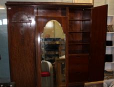 Edwardian oak three door wardrobe: with drawers, shelves and hanging rail to the interior. Central