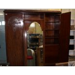 Edwardian oak three door wardrobe: with drawers, shelves and hanging rail to the interior. Central