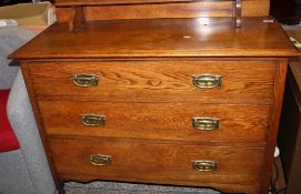 Victorian oak chest of three long drawers: with gallery back raised on castors