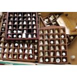 A collection of souvenir thimbles in wooden wall mounting display stands: (1 tray).