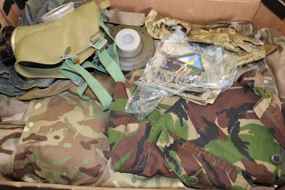 A quantity of camouflage clothing: shirts, pair of gloves, gas mask etc (1 tray).