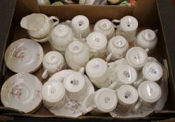 A collection of pink floral tea and coffee ware items: mugs, saucers, cups, milk and sugar etc (1