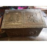 A Large Embossed Brass covered Log Box: with Tavern Scenes, 80cm wide, 45cm deep x 58cm high, in