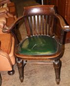 Oak Captains chair: on turned tapered legs, green leather seat. 67cm wide