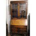 Early 20th Century oak bureau/bookcase: fall front and two long drawers to base, glazed bookcase