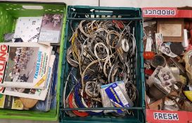 A collection of cycling related items: vintage bike parts, brake/gear cables, books and magazines