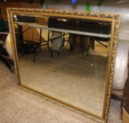 A very large gilt framed bevel edged mirror: 124cm x 103cm.