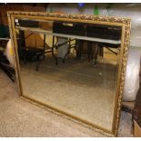 A very large gilt framed bevel edged mirror: 124cm x 103cm.