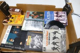 A collection of Beatles memorabilia: to include Twist and shout 45rpm, books, etc