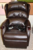 A 'Celebrity' branded recliner/riser armchair: in chocolate brown leather finish.