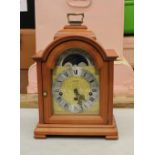 A Keininger mantle clock: cherry wood case.