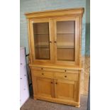 Modern, good quality honey oak display cabinet: with glass shelves and lights to the interior, (