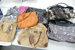 A collection of ladies bags: to include leather hand bag, shoulder bags. Some brand new with tags (