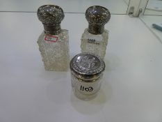 A pair of Edwardian silver topped rectangular cut glass scent bottles AF hallmarked London 1906, sli