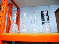 4 Similar crystal glass decanters with handles