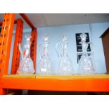 4 Similar crystal glass decanters with handles