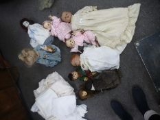 8 Vintage dolls, all in vintage clothes, and a quantity of christening gowns and other antique linen