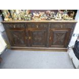 19th Century heavily carved continental oak dresser base with 3 drawers above cupboards